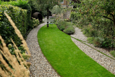 A overhead shot of a narrow green lawn with paths running eitherside