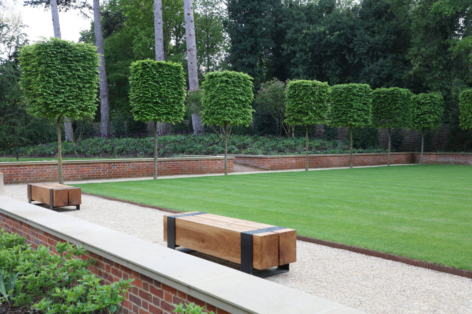 Harpsden Wood House bowling green with benches and cube head shaped trees