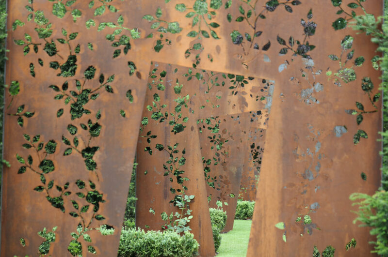 corten laser cut doorways in a magical rose garden harpsden wood house