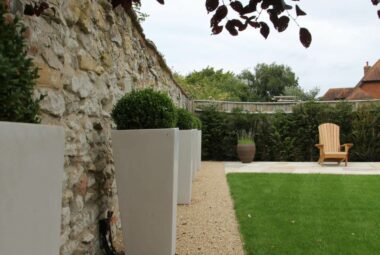 White ceramic cube planters with topiary ball