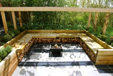 a sunken garden with slate paving and built in seating at a barn conversion garden