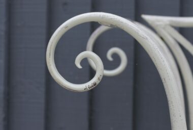 Curled edge of white metal planter