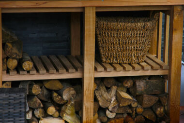 piles of logs inside wooden garden unit