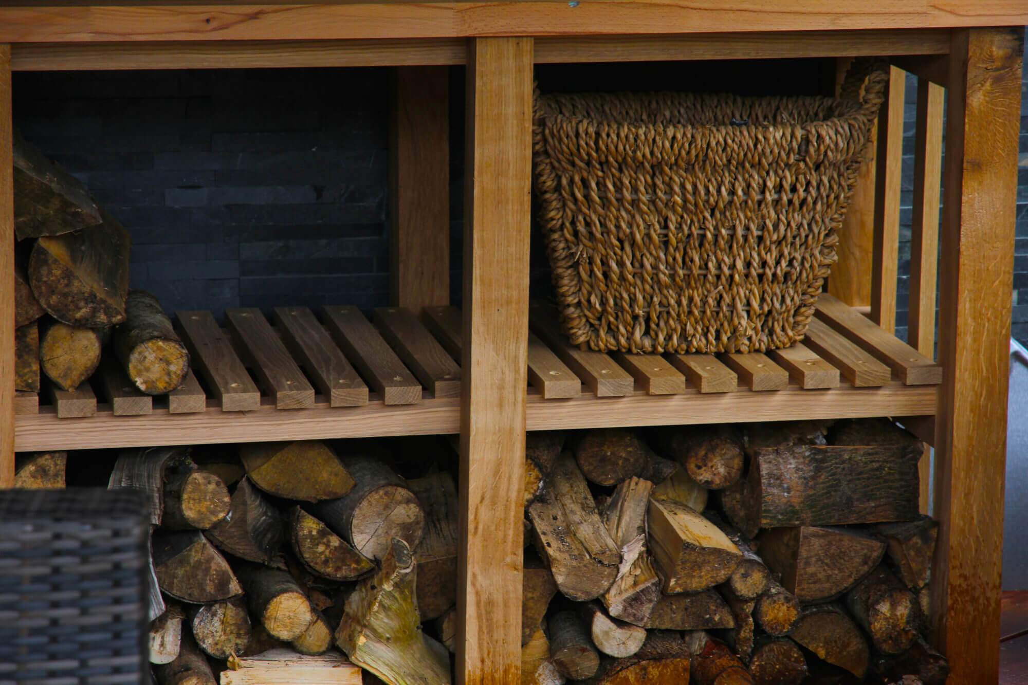 piles of logs inside wooden garden unit