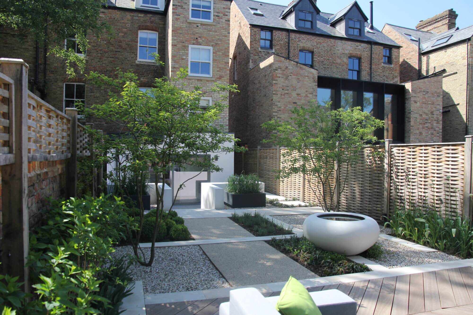 back of Victorian townhouses in Oxford with garden designed and multi stem trees