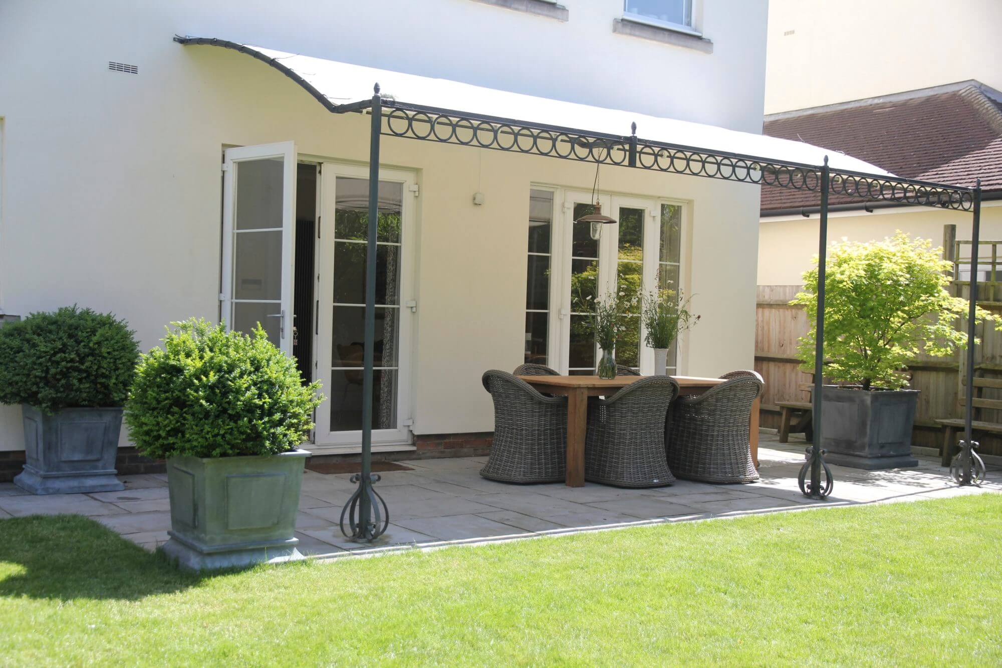 Table and chairs under canopy in garden