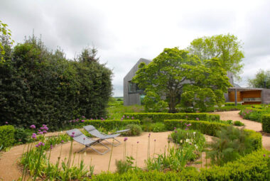 a wild walled garden full of structural and seasonal planting