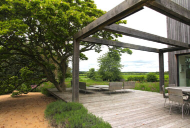 modern barn garden with Harwood decking and a giant Magnolia tree growing out of the deck