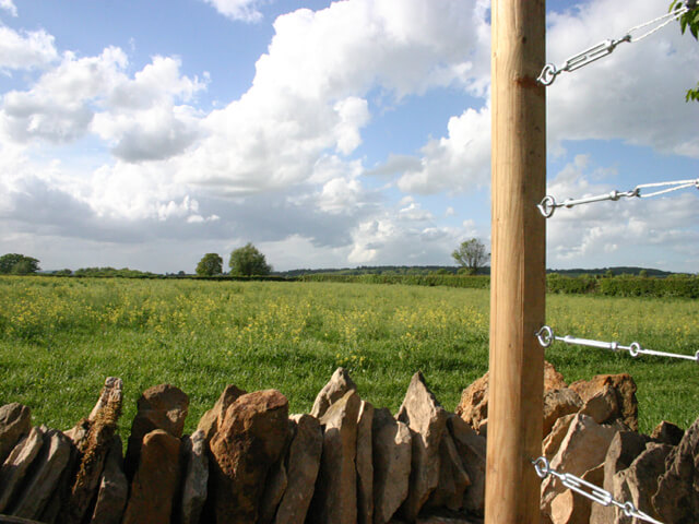 pergola post against blue sky and drystone walls in Kingham