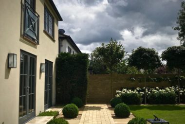 townhouse garden in Oxford cobbled path and buxom balls on a sunny day