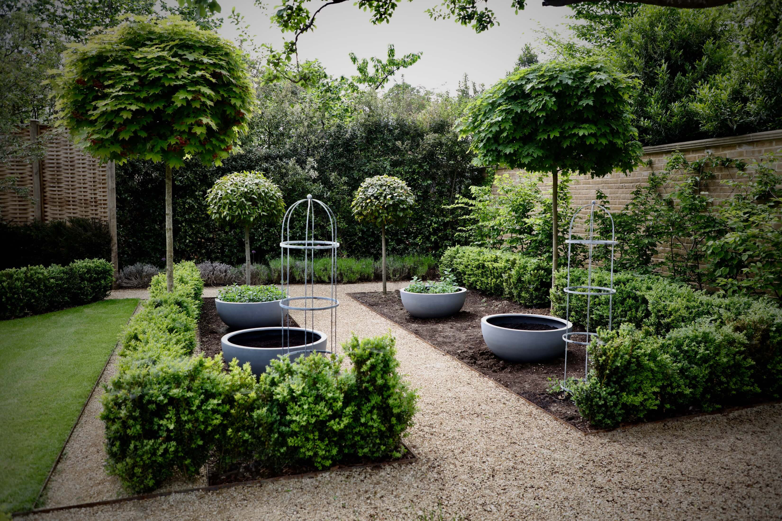 townhouse garden in Oxford productive garden with obelisks and bowl planters