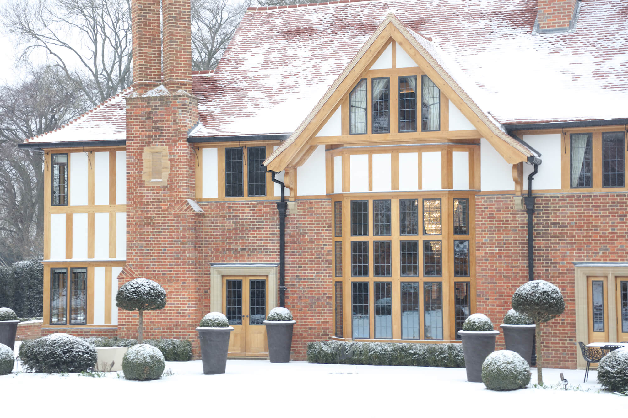 arts and crafts house covered in snow with chandelier interior