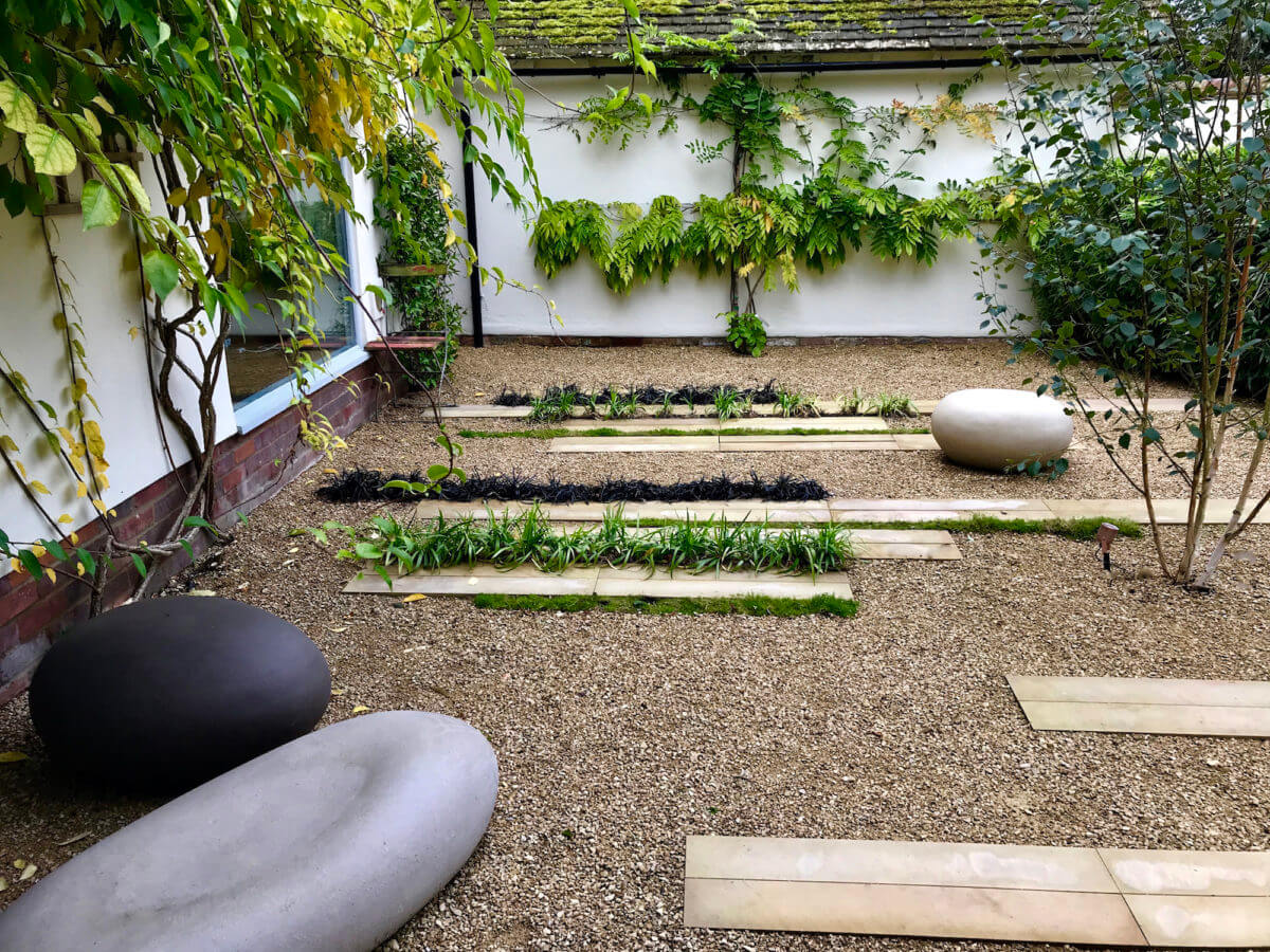modern courtyard garden with giant pebbles by designers in Oxford