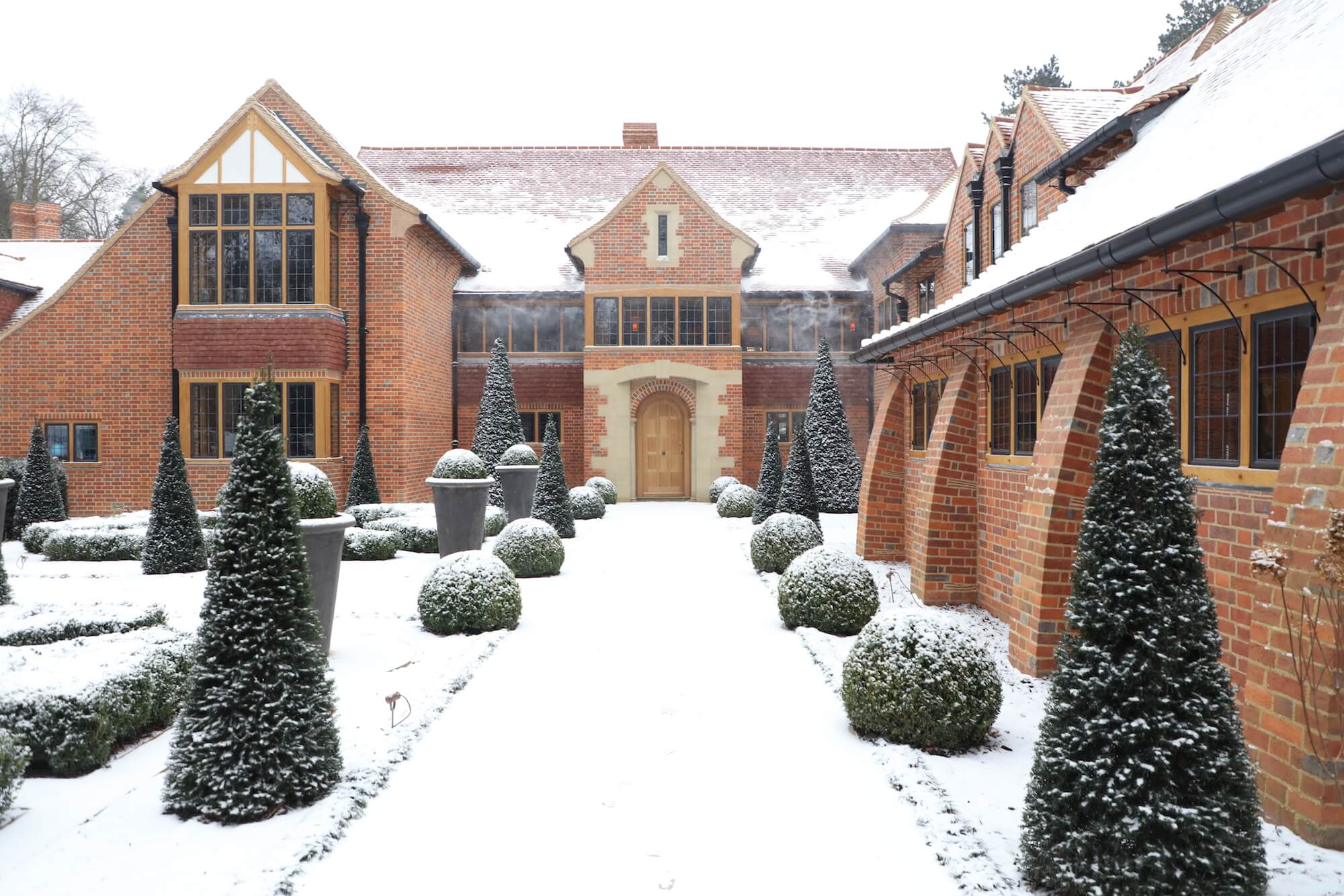 Harpsden Wood House at Christmas front door to arts and crafts house by Jonathan lees architects