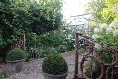 Woven willow fences and a victorian glasshouse and productive gardens