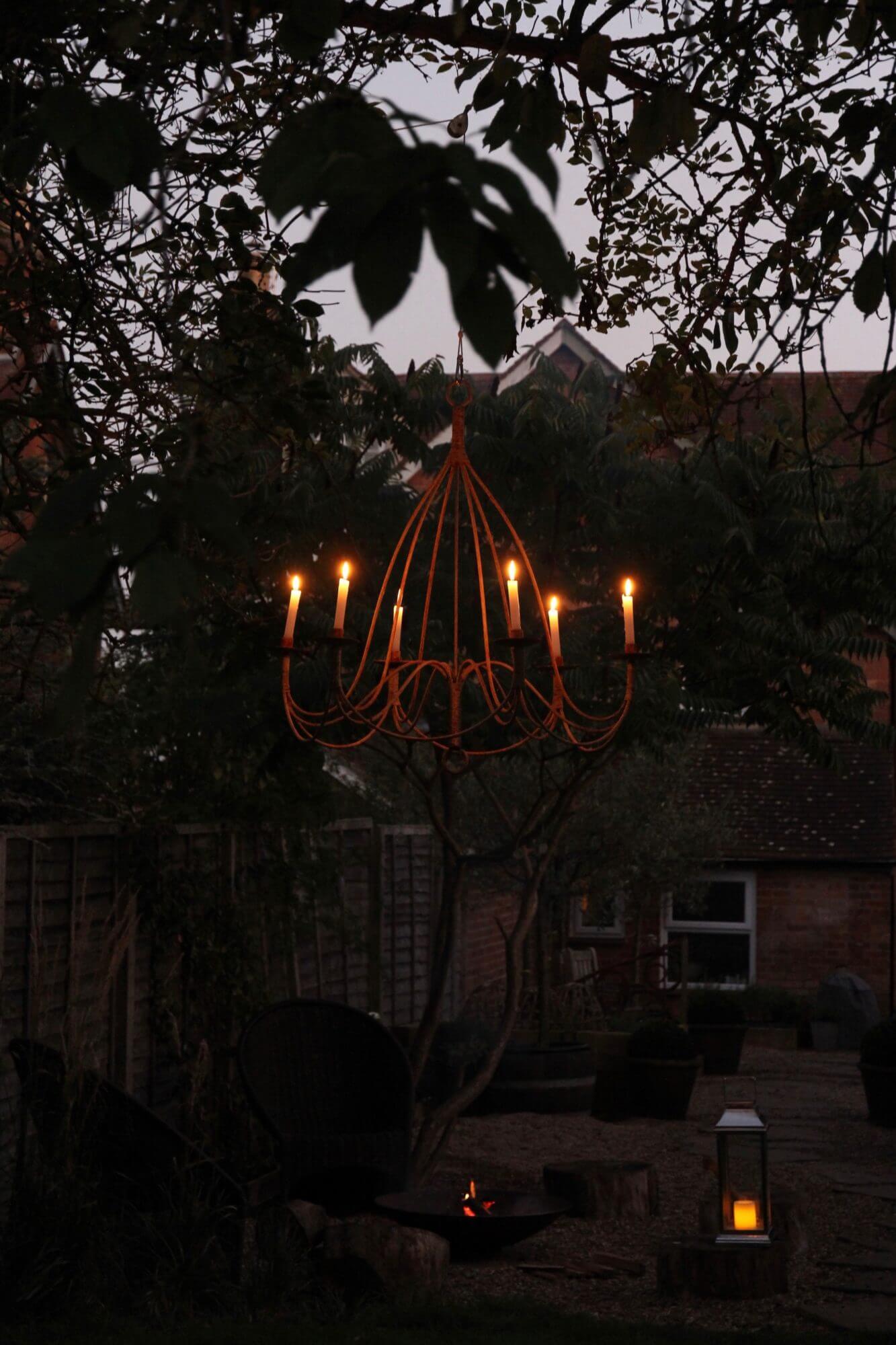 Garden at night with chandelier, fire pit and laterns