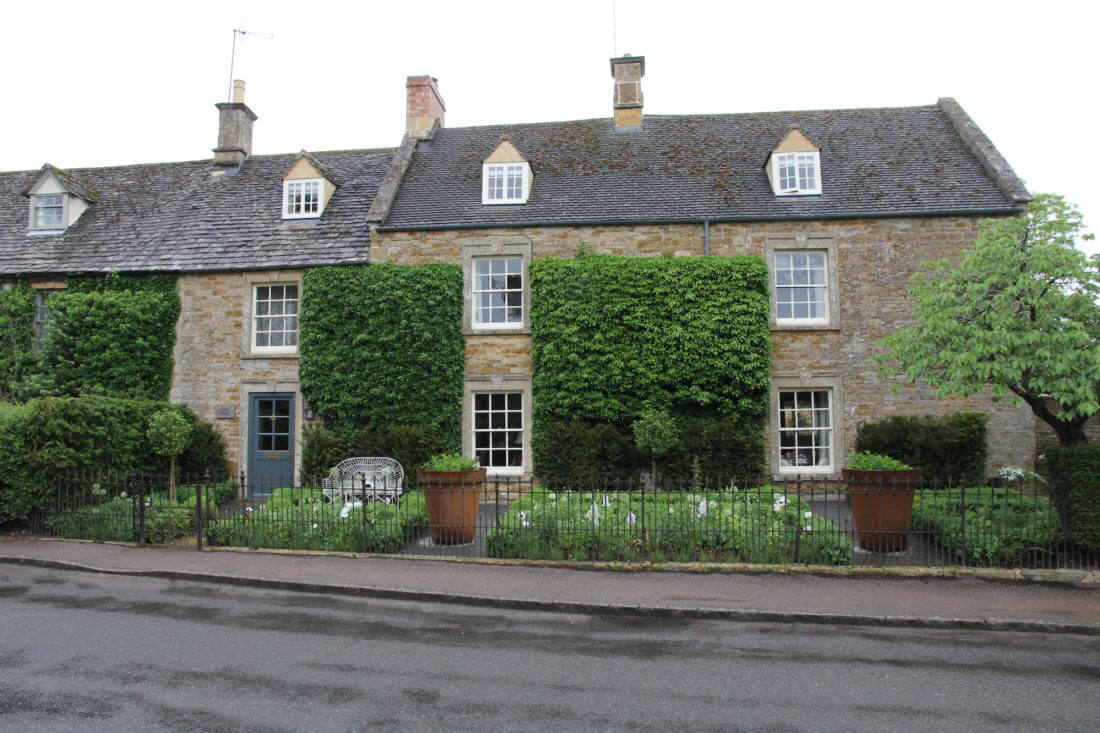 judges house front garden in Kingham village with downpipes door