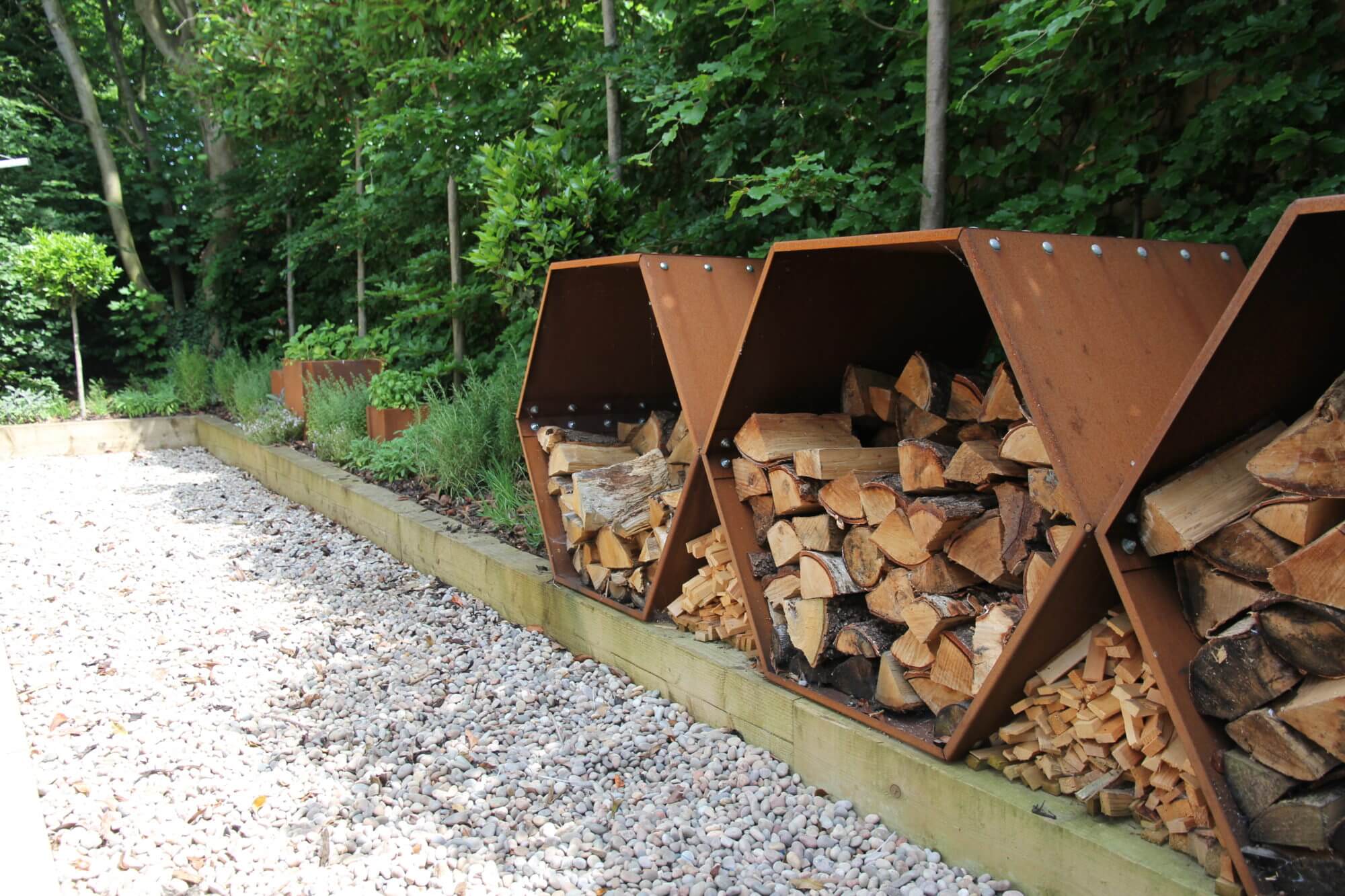 corten hexagonal log store with kiln dried logs stacked inside