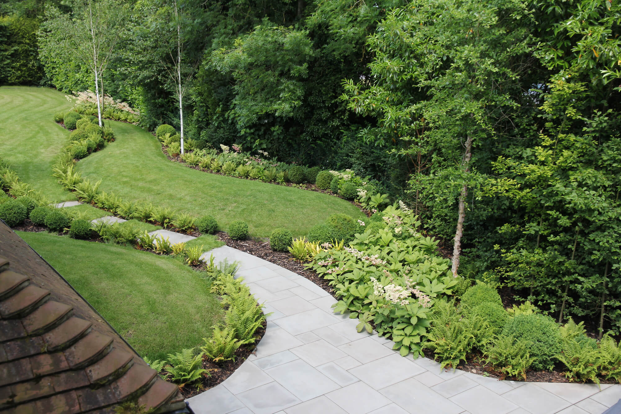 Winding pathways through lawn of sculptured garden