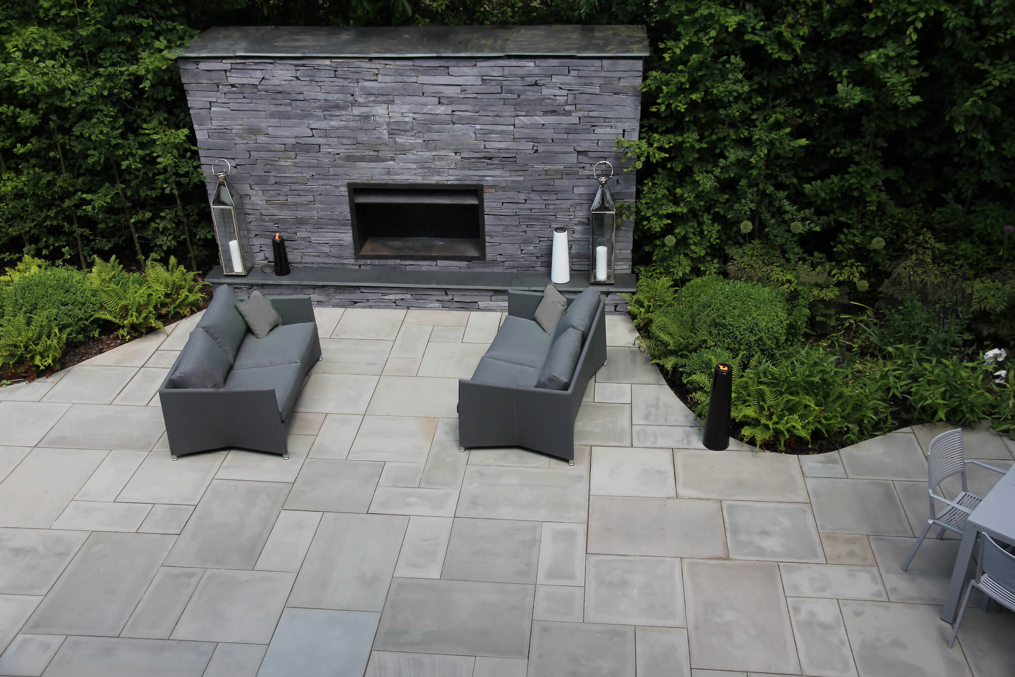 outdoor fireplace in slate with sofas in an Oxford garden design