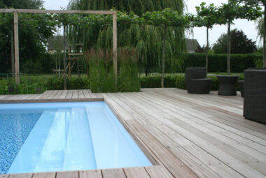 blue swimming pool surrounded by deck