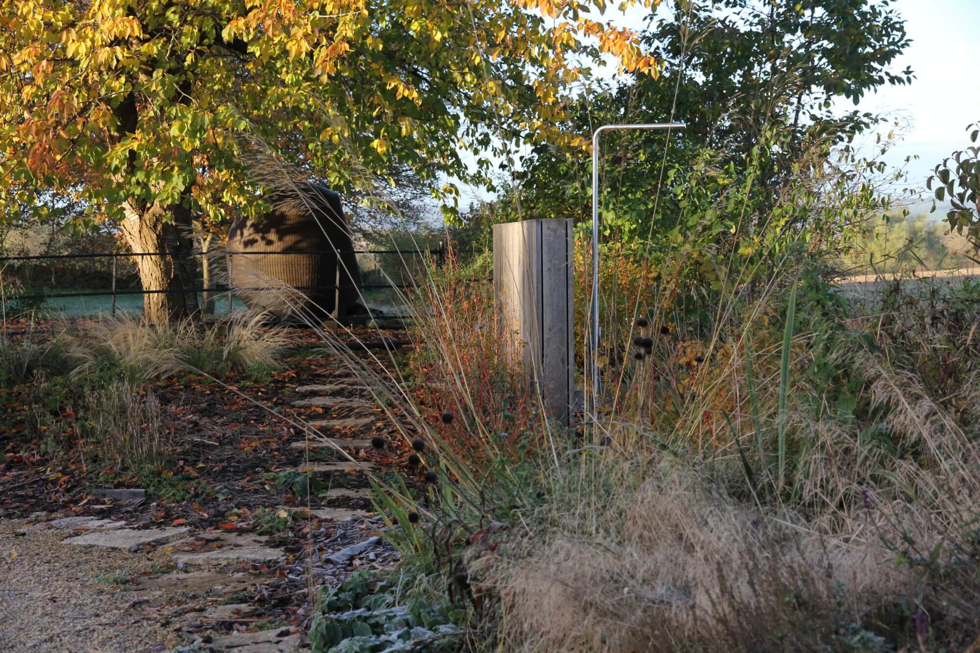 outdoor shower by a natural swimming pool