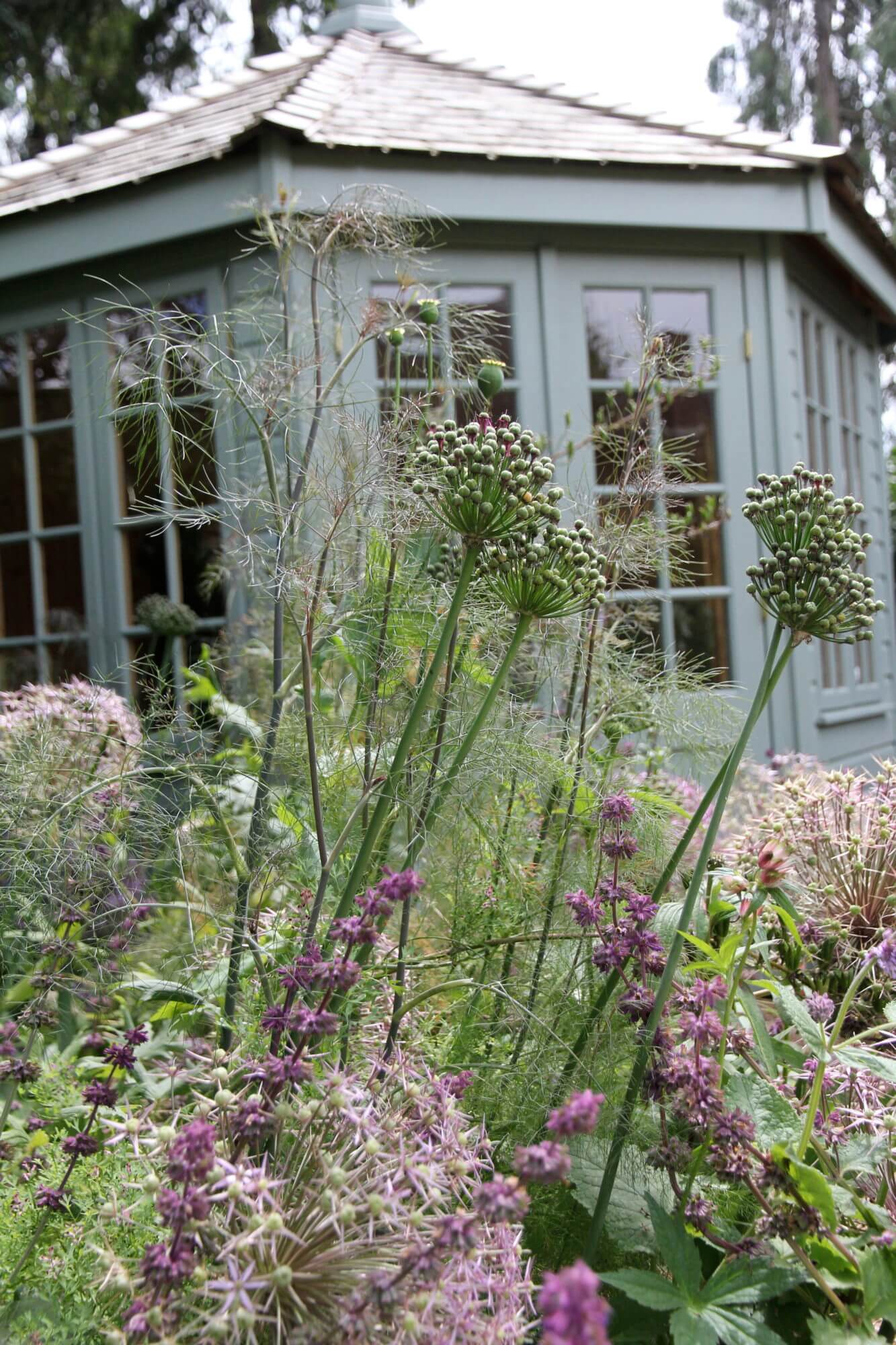 Victorian garden house with summer flower patch