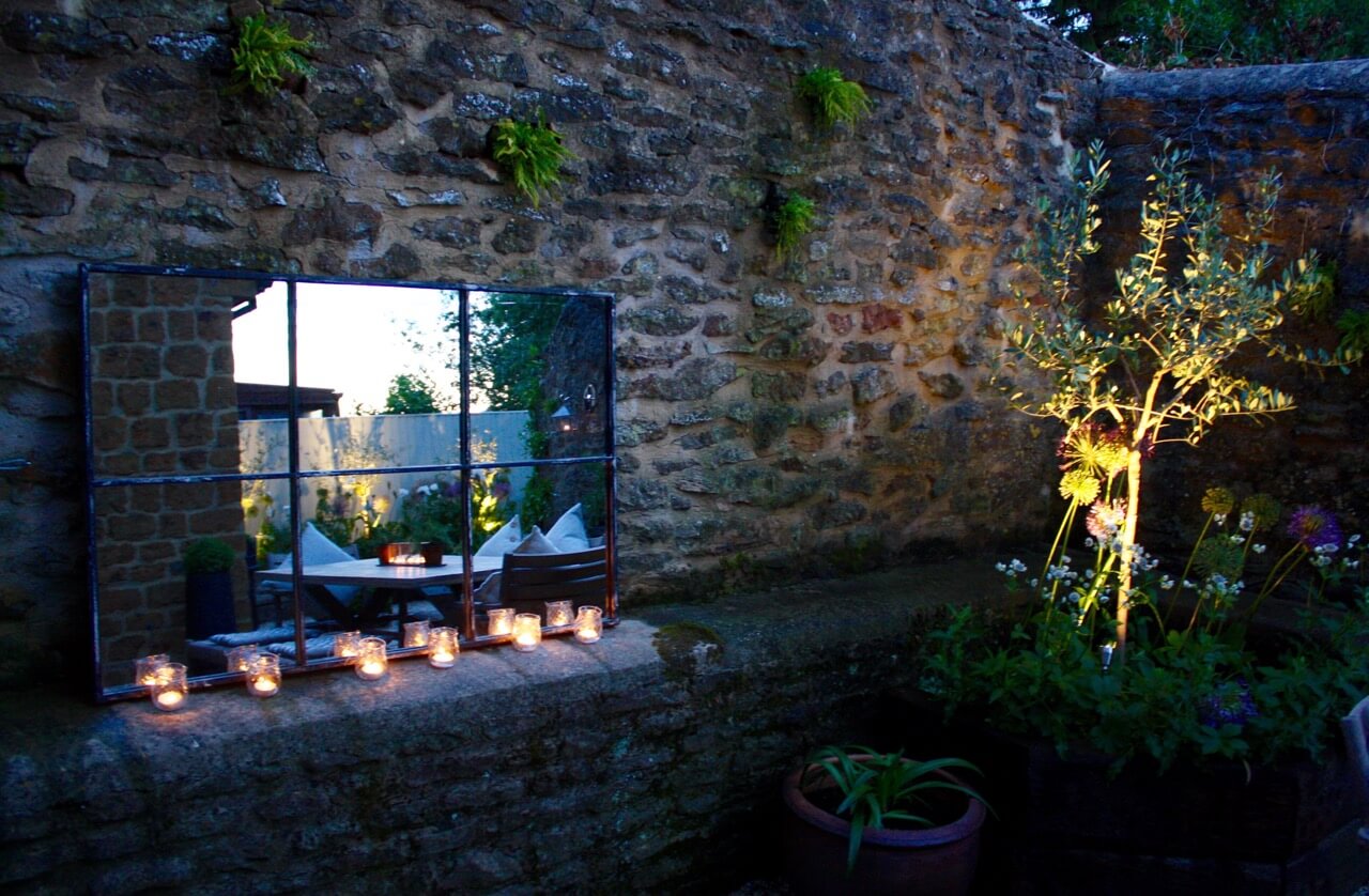 small courtyard garden with outdoor mirror and garden light in Oxfordshire by garden design team