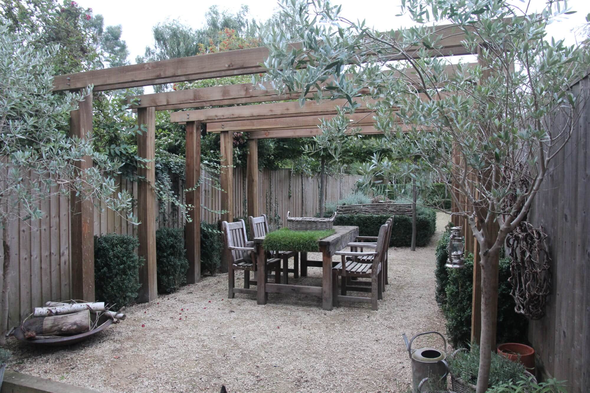 modern townhouse garden with wooden roofs and green topiary