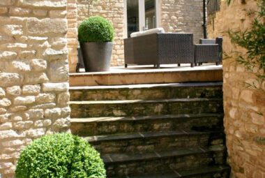 Steps leading to courtyard with garden furniture