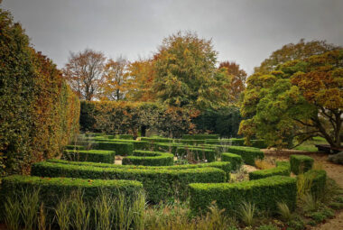 natural walled garden in Kingham go Beech with swirly buxus parterre and autumn colour