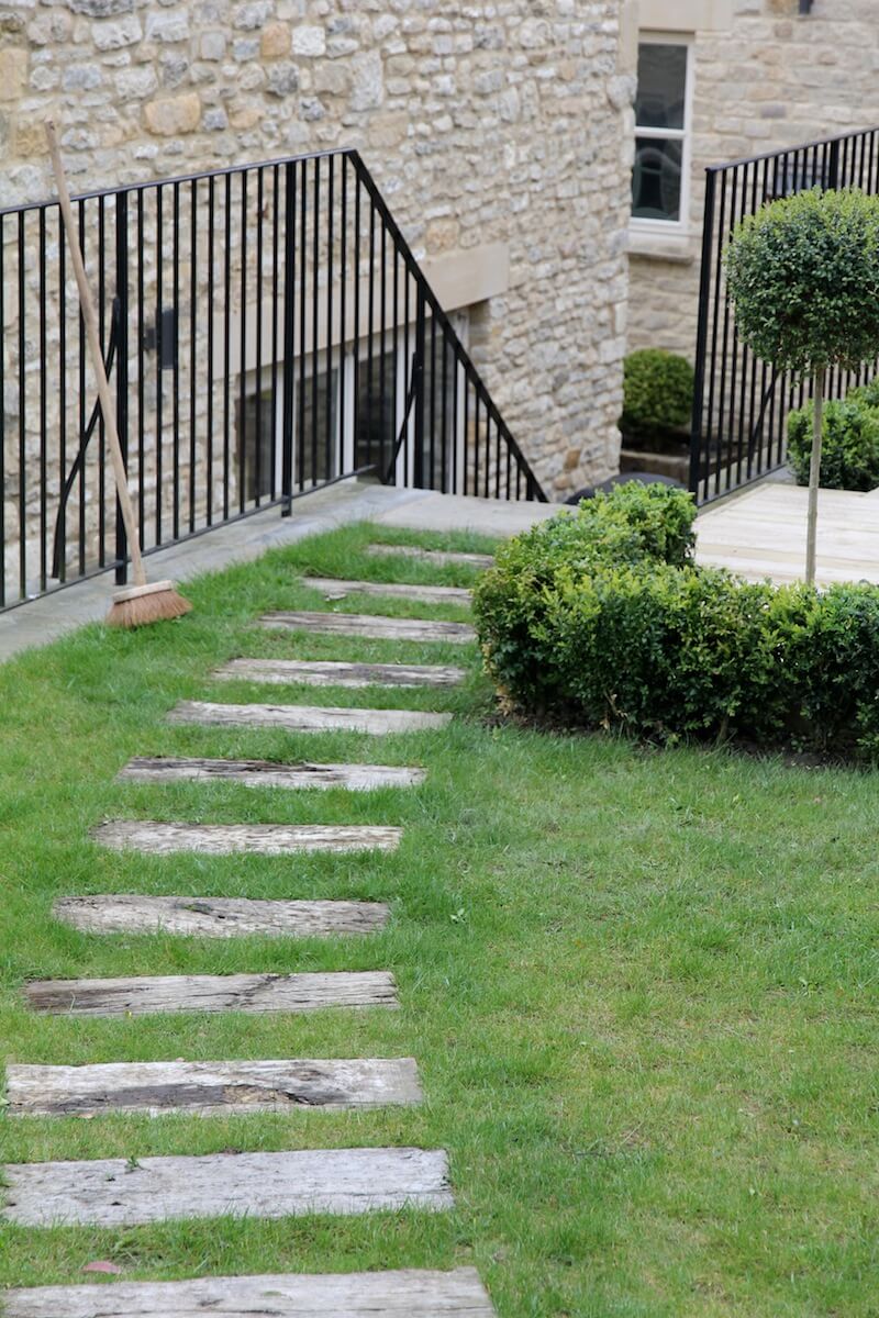 Stepping stones across garden lawn