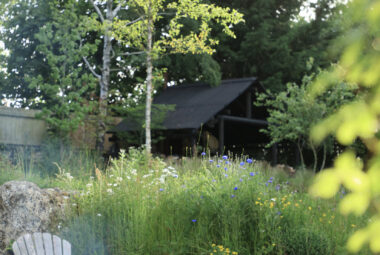 Adirondack chairs in front of cotswold stone wall