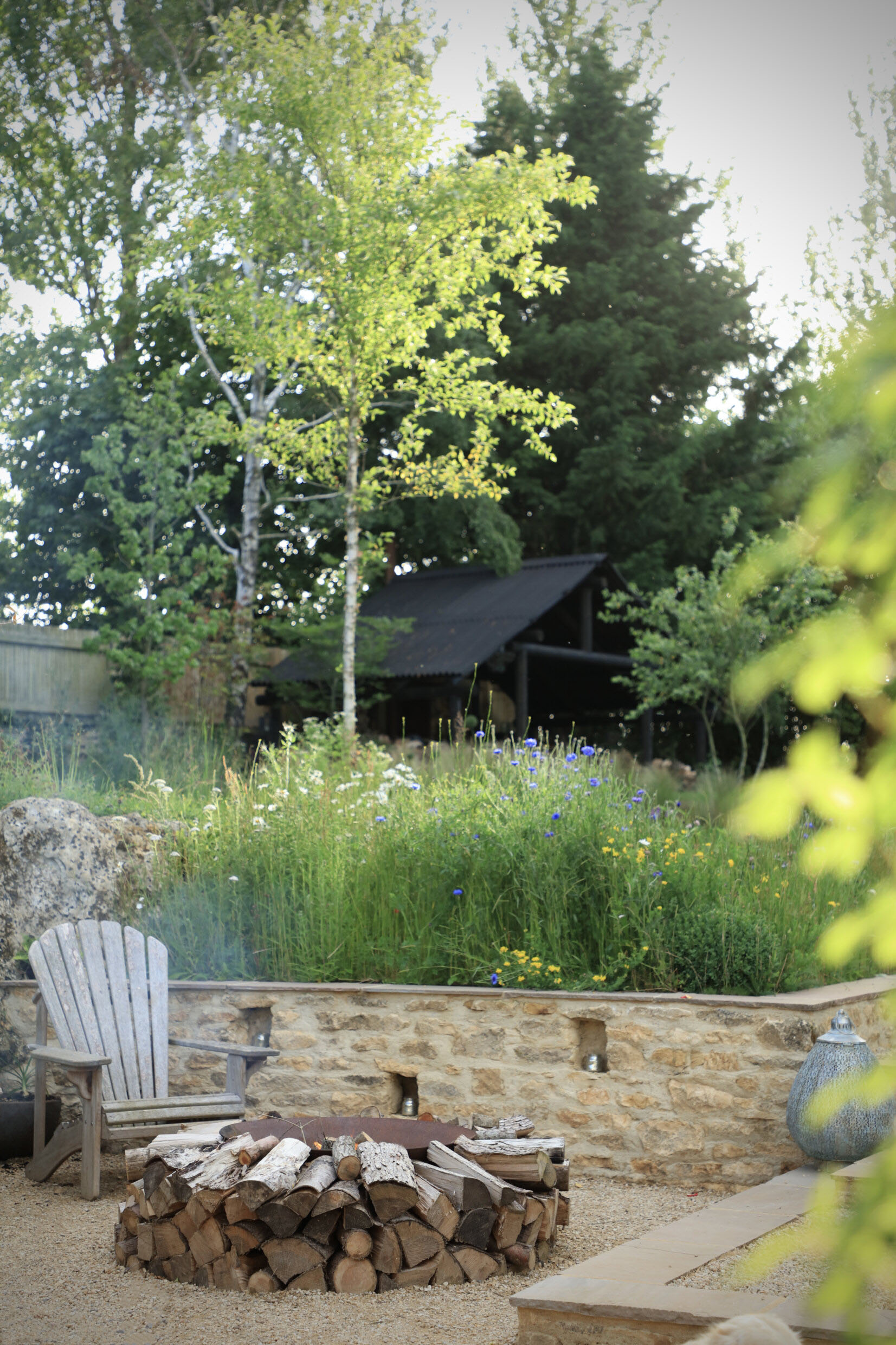 Adirondack chairs in front of cotswold stone wall