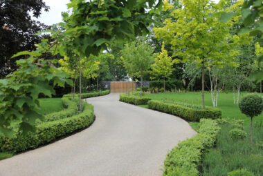 Entrance to North End with lots of trees and topiary