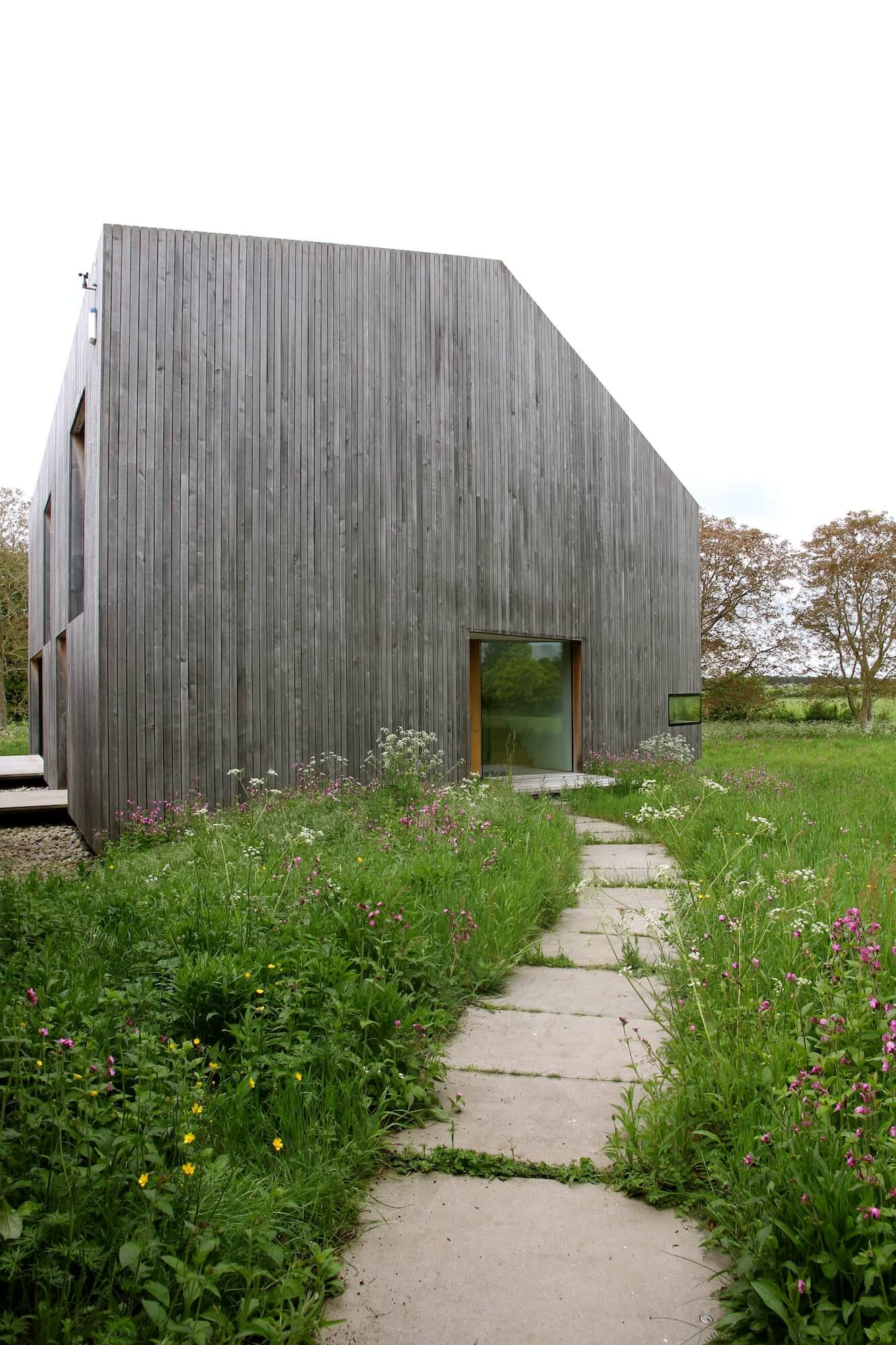 modern barn entrance with wildflower pathway entrance