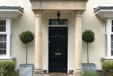 bay tree front garden with black door London