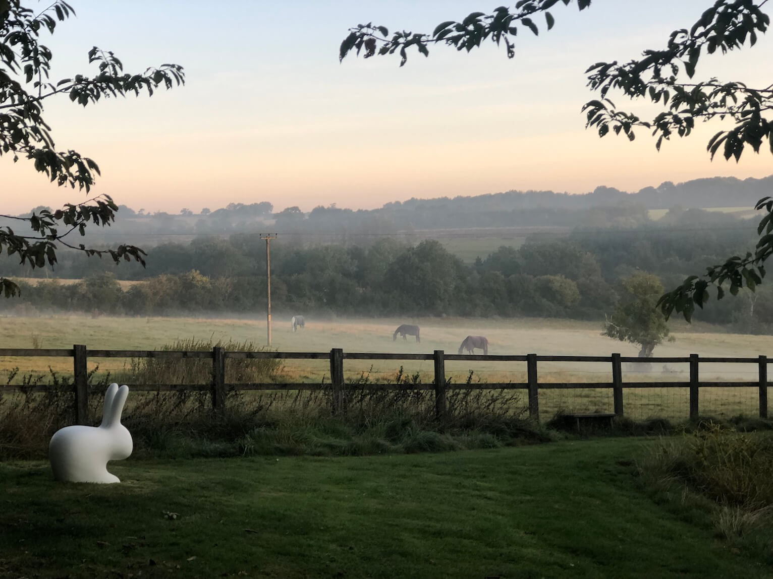 autumn harvest field with rabbit sculpture