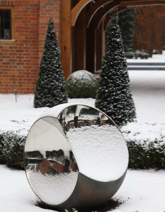 Round garden sculpture in artisan landscape