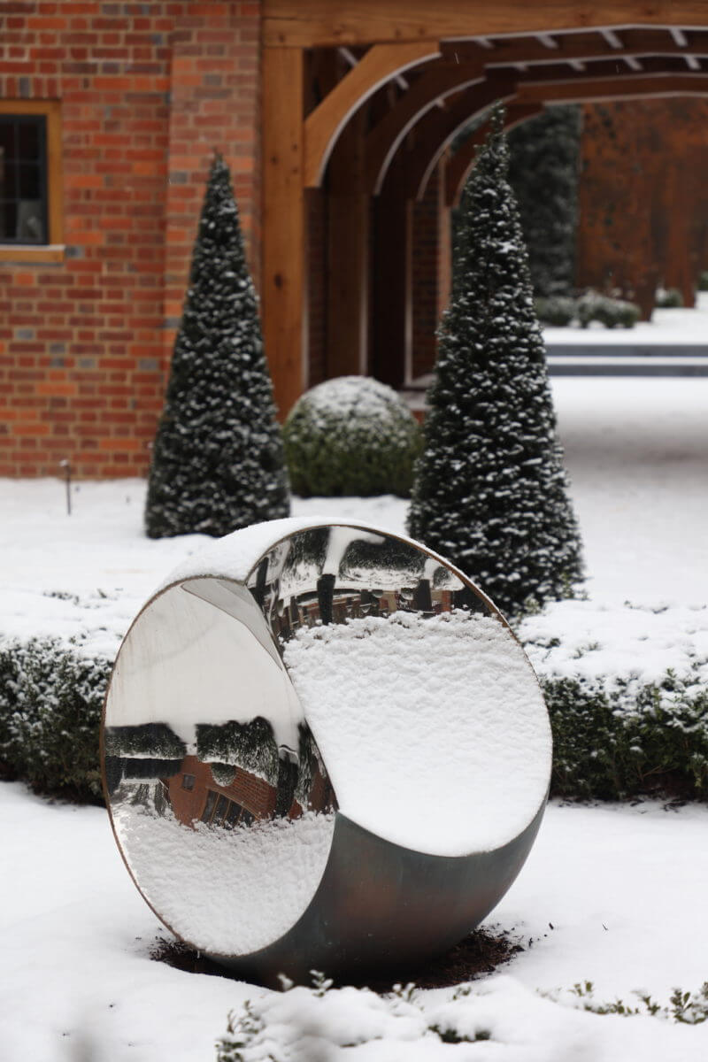 Round garden sculpture in artisan landscape