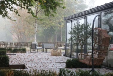 designer lakeside garden property in Oxford with fallen leaves on a large deck music studio in garden