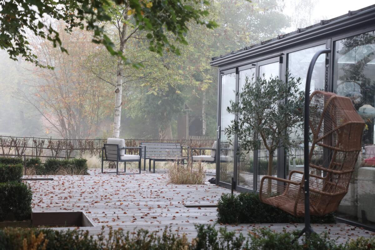 designer lakeside garden property in Oxford with fallen leaves on a large deck music studio in garden