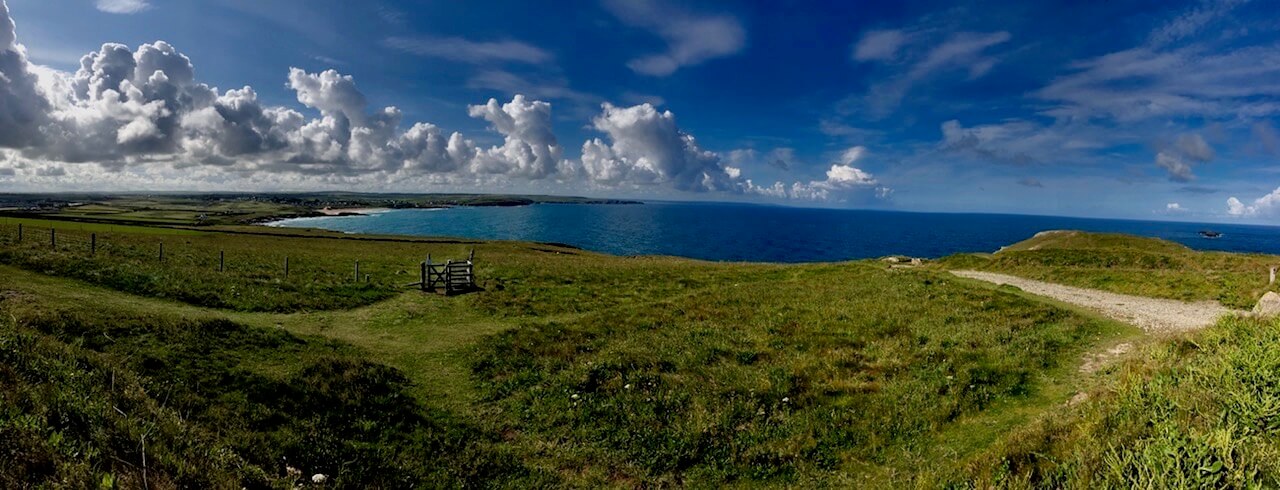 a wide angle shot of the ocean and bay Constantine bay in Cornwall