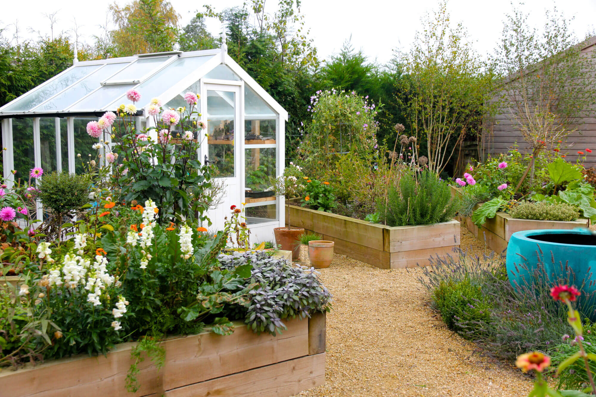 Glass garden potting conservation surrounded by cut flower patches