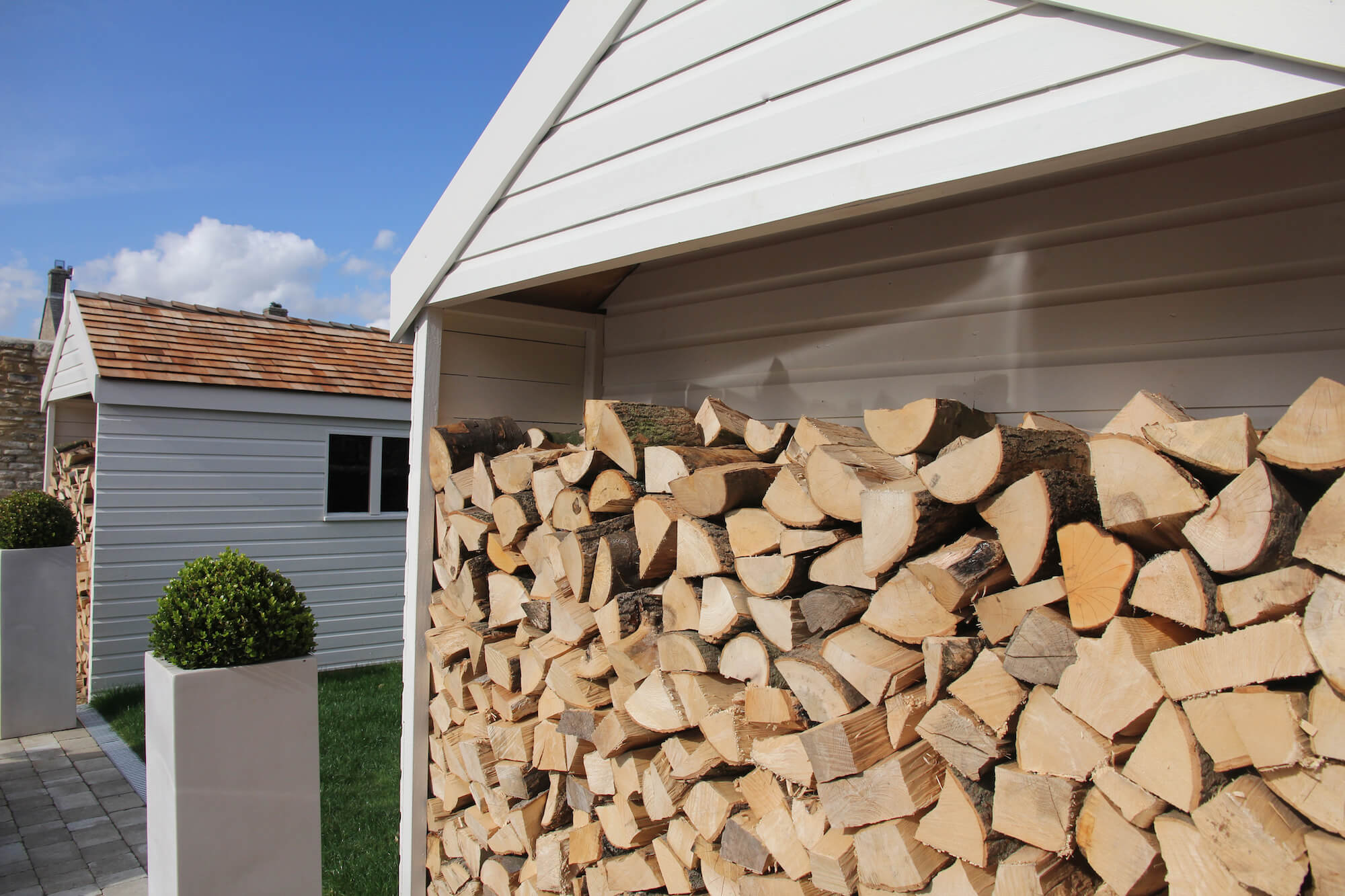 log store sheds outside a townhouse