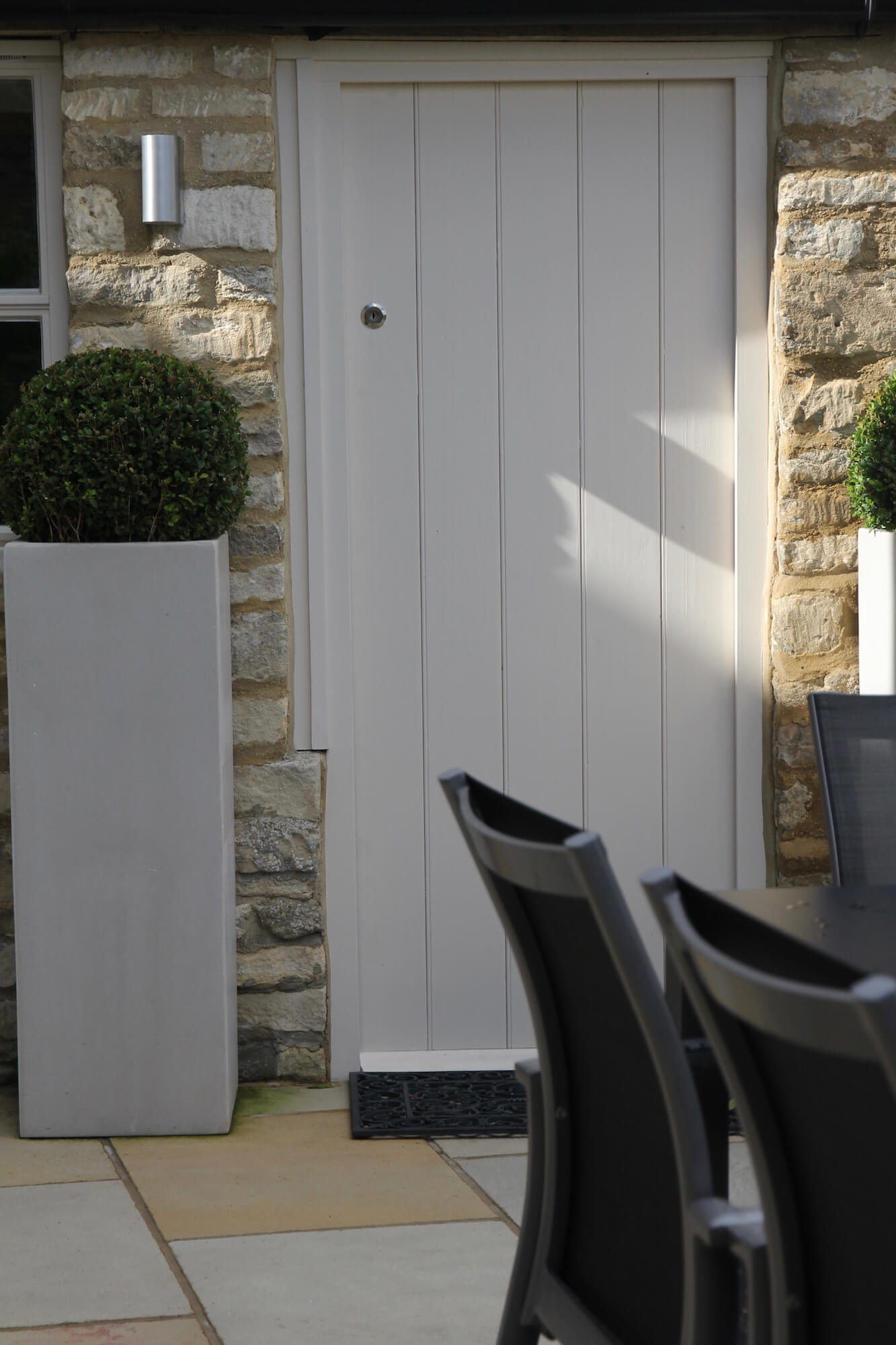 townhouse garden office door way with buxus ball planter