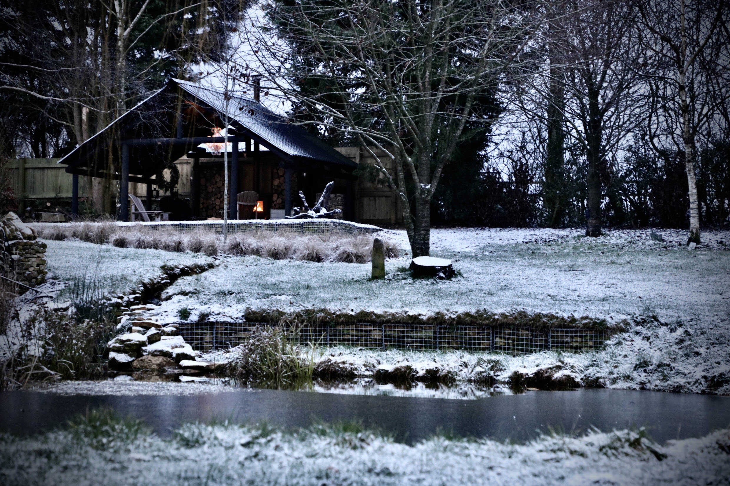 View of garden shack with wood fired hot tub and fire pit