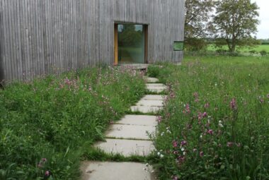 barn in Kingham with wildflower meadow mown paths leading to it