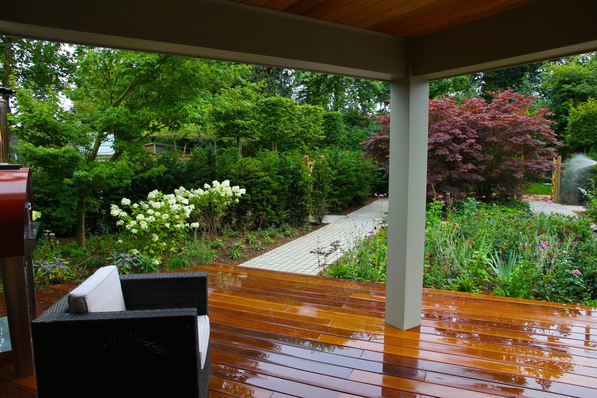 Garden check on wet wooden decking under shelter