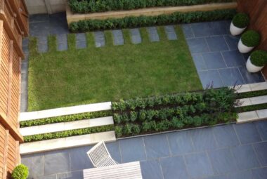 a small oxfordshire garden designed with slate paving and lawn